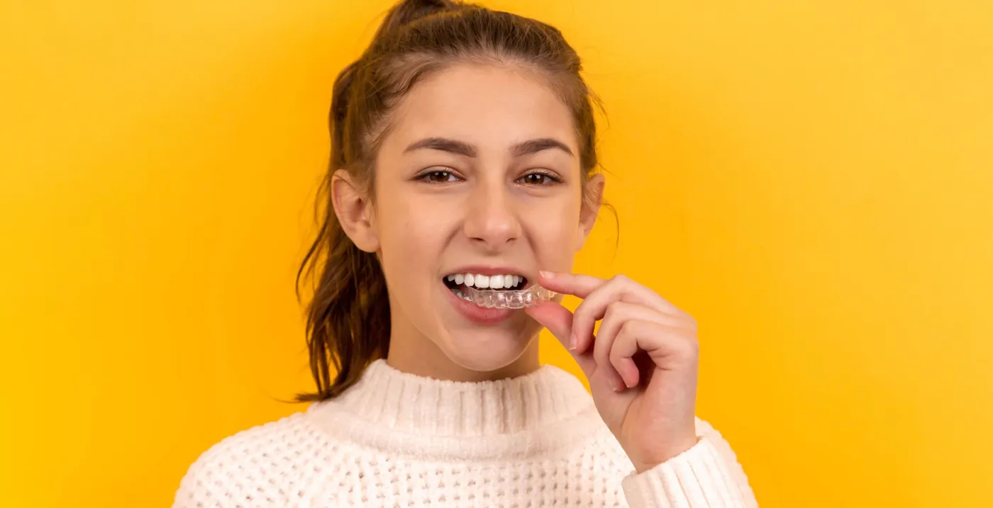 Teen placing a clear aligner