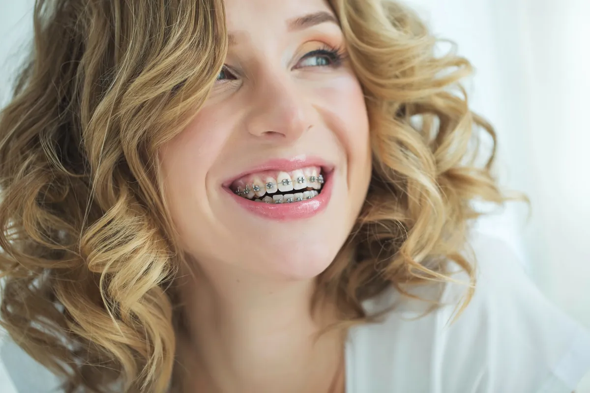 Smiling woman with metal braces